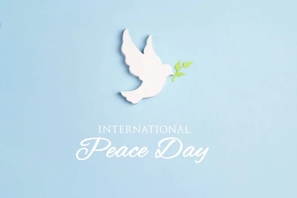 World Peace Day greeting card. Dove of peace with olive branch o