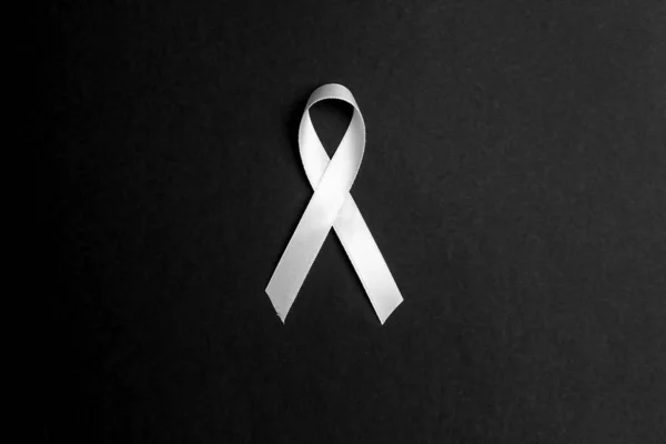 Lung cancer awareness ribbon on black background. November lung