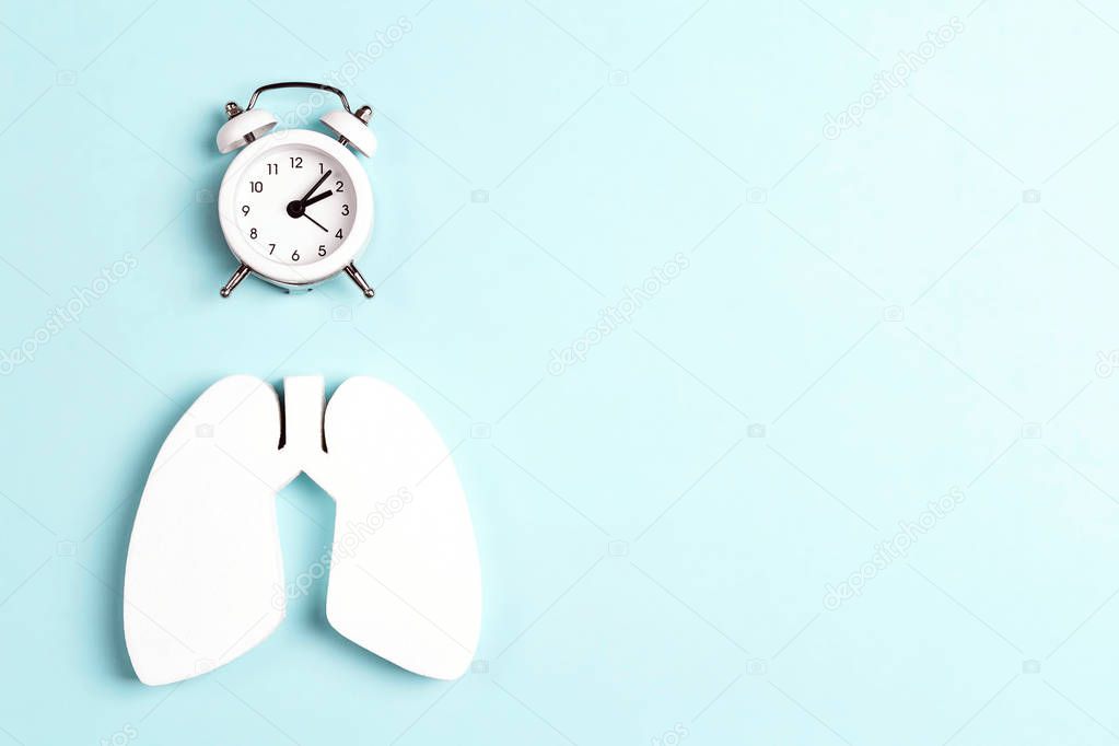 Prevention of pulmonary disease. Lung symbol and alarm clock on 