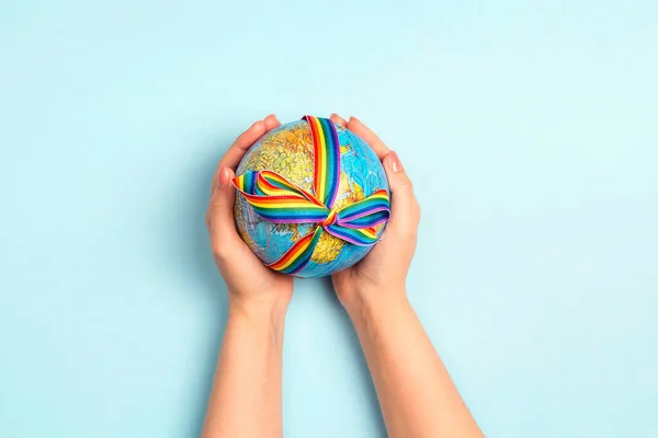 Female Hands Holding Globe Lgbt Rainbow Ribbon Blue Background Lgbt — Stock Photo, Image