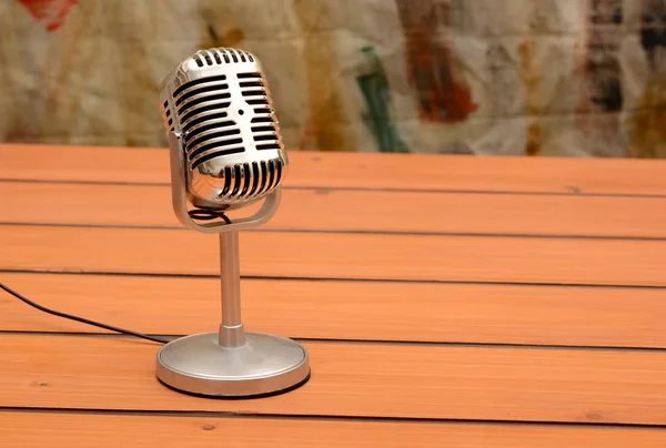 Microfoon stock beeld op houten achtergrond, old school microfoon — Stockfoto