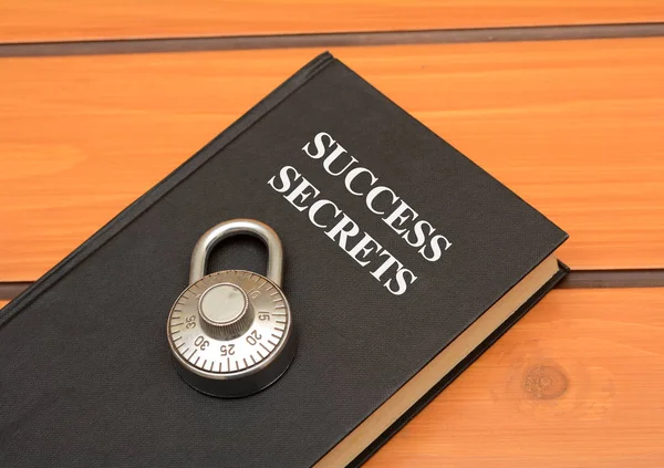 Success secrets concept with book on wooden background