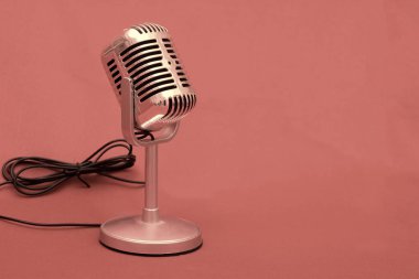 Old Microphone stock photo on pink background