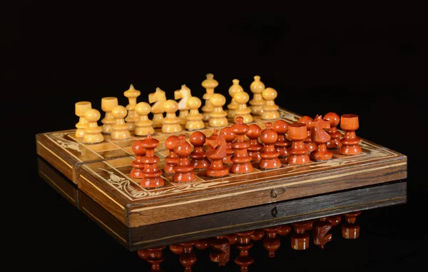 Wooden Chess with pieces on black background — 스톡 사진