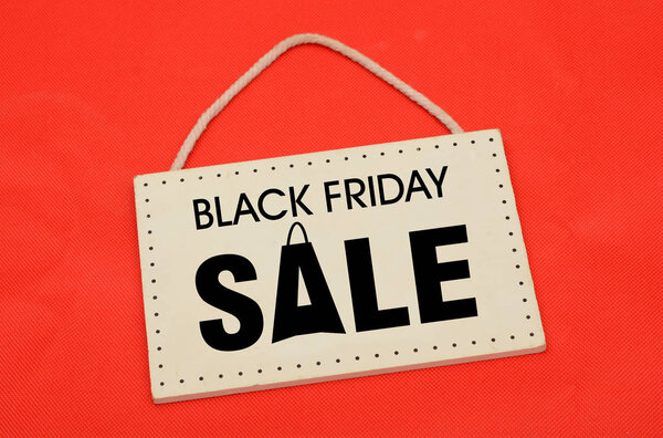 Black friday sale sign on red cloth backgorund