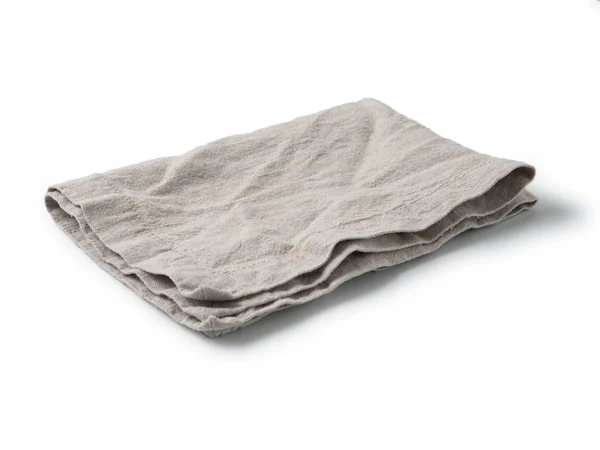 Side view on folded gray linen napkin isolated on white background. light gray linen napkin. Isolated on white with clipping path.