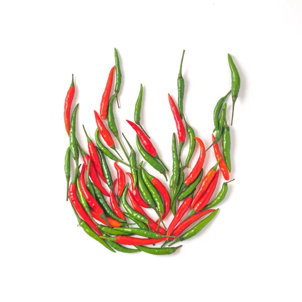 Creative layout chilli peppers. Fire or bonfire shape made from green and red hot peppers. Isolated on white with clipping path. Copy space for text. Top view or flat lay.