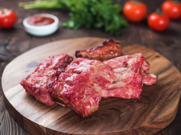 pork ribs on wooden plate. Ready-to-eat pork ribs. Selective focus. Copy space