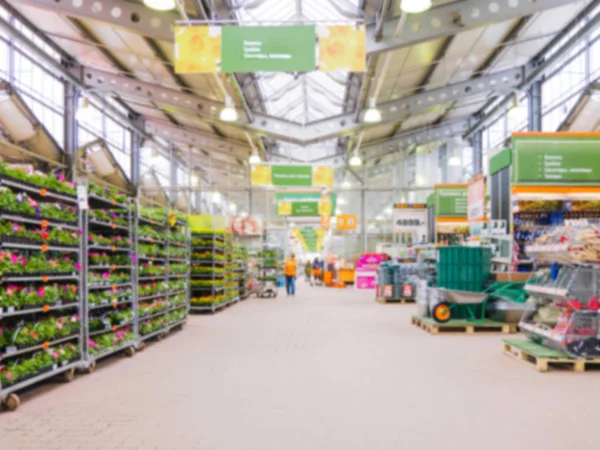 Abstract blurred hardware store aisle with garden goods as background