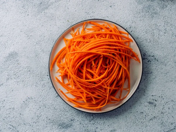 Raw carrot noodles or spaghetti, top view