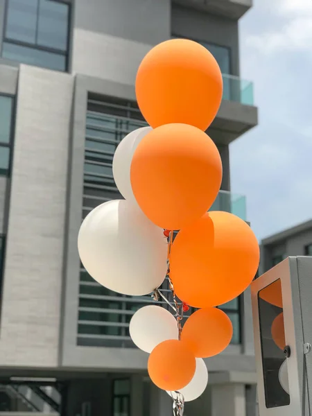 Group of orange and white balloons
