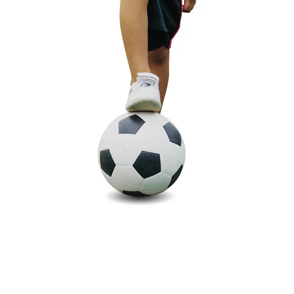 The boy in sportswear wearing sneakers is stepping on a soccer b — Stock Photo, Image