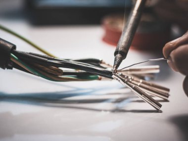 Elektrikçiler kabloları bağlamak için lehim makinesi kullanıyorlar. 