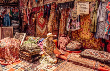 Young lady in carpet shop in Cappadocia. Goreme. clipart