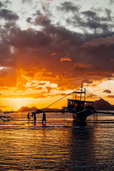 Philippines. Local boat\'s silhouette at the bay. Sunset sky. El Nido.