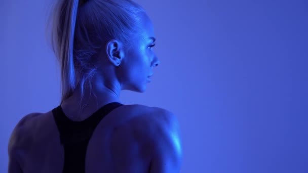 Happy fitness žena v modré neonové světlo, Bikiny, fitness a sportovní výživa reklama — Stock video