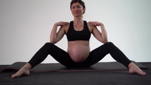 Schwangere Brünette beim Yoga. authentischer Stil mit natürlichem Licht und Schatten. — Stockvideo