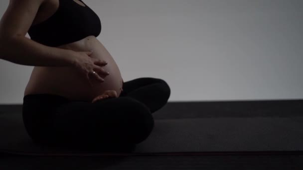 Zwangere brunette meisje doet yoga. Authentieke stijl met natuurlijk licht en schaduwen. — Stockvideo