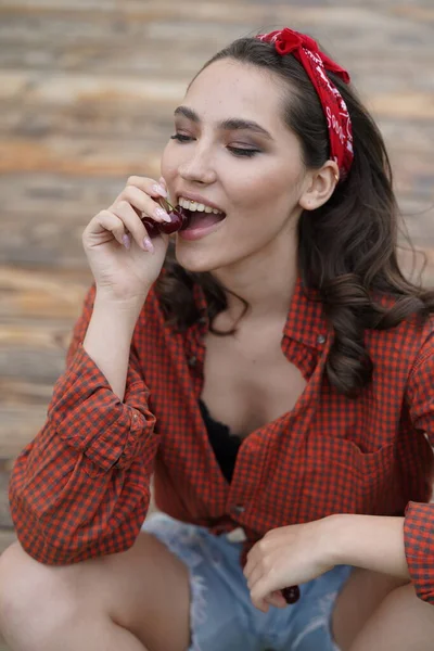 Portret pięknej kobiety jedzącej wiśnie. Celuj w kobiece usta. Na zewnątrz — Zdjęcie stockowe