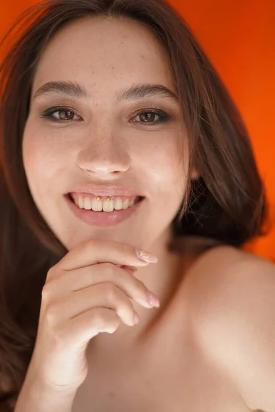 Young woman open eyes on white background. Close up of smiling girl looking at camera in studio. Curly hair fashion model face smiling. Portrait of joyful girl open eyes. Female nature beauty