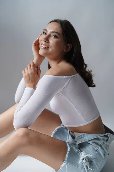 Wanita muda membuka mata pada latar belakang putih. Menutup gadis tersenyum melihat kamera di studio. Keindahan alam perempuan — Stok Foto