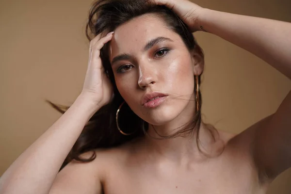 Retrato de una mujer hermosa con el pelo largo. Joven modelo morena con hermoso cabello - aislado sobre fondo blanco. Chica joven con el pelo volando en el viento. —  Fotos de Stock