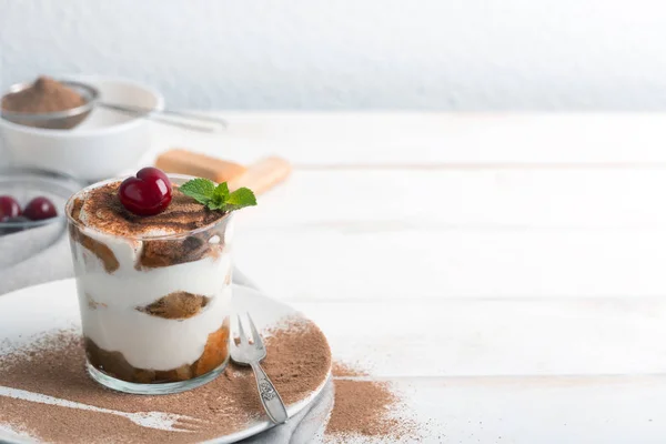 Tiramisu and cherry in a glass cup — Stock Photo, Image