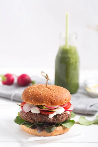 To make a vegetarian burger, combine the cooked beans and kinoa in a blender and make a cutlet. Stir a roll and put a cutlet and a lot of fresh vegetables. As a beverage you can prepare celery smoothie drink