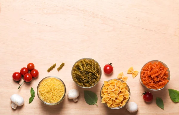 Different types of Italian pasta with vegetables on the table — Stock Photo, Image