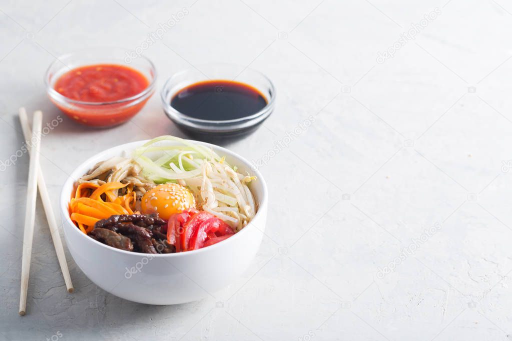Traditional Asian Bibimbap dish with rice and vegetables