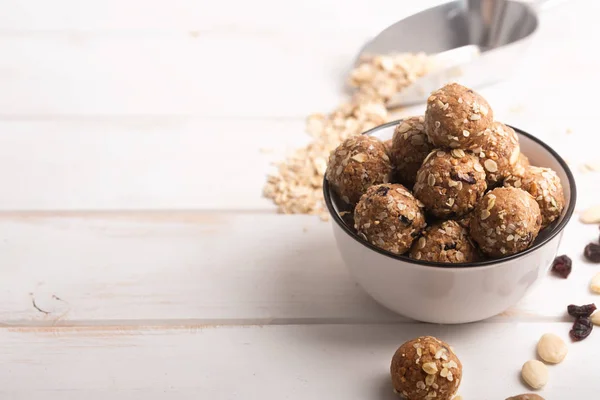 Healthy organic energy granola bolls with nuts, cacao, oats and raisins - vegetarian sweet bites without sugar. Copy space for text — Stock Photo, Image