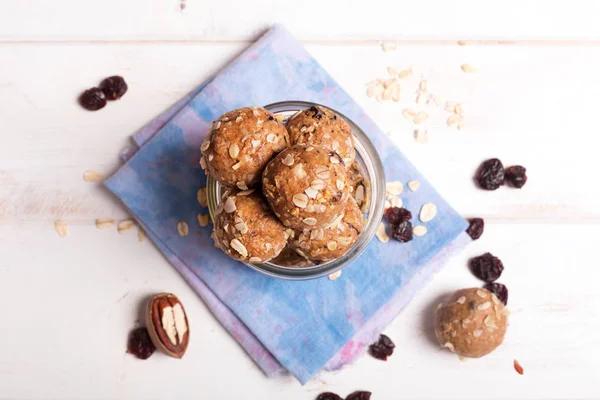 Healthy organic energy granola bolls with nuts, cacao, oats and raisins - vegetarian sweet bites without sugar