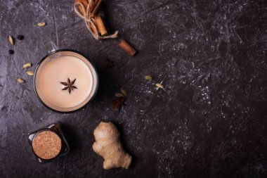 Flavoured tea chai made by brewing black tea with aromatic spices and herbs. Top view with copy space