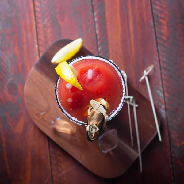 Cocktail Bloody Mary met ijs, zout en snacks in glas op een houten tafel. Plat leggen — Stockfoto