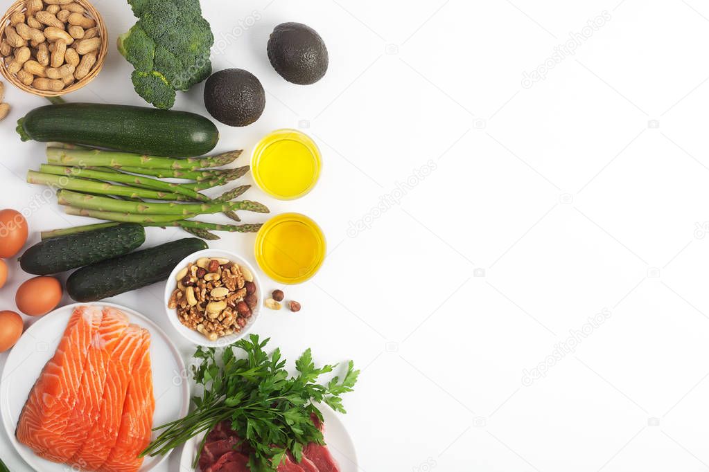 Ketogenic, keto diet, including vegetables, meat and fish, nuts and oil on white background with copy space