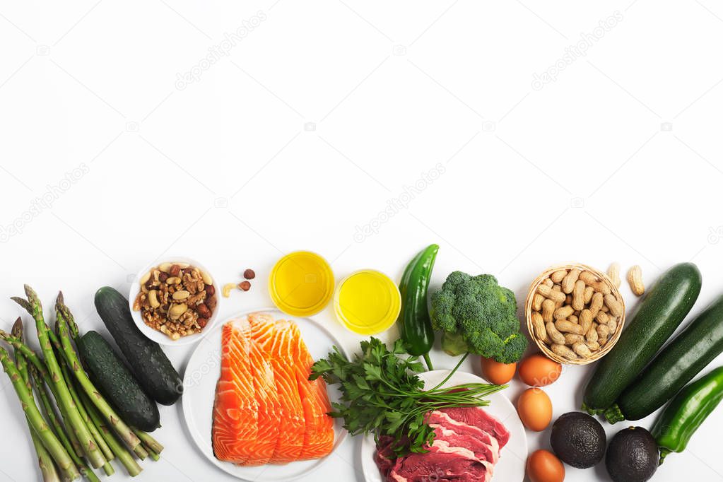 Ketogenic, keto diet, including vegetables, meat and fish, nuts and oil on white background with copy space