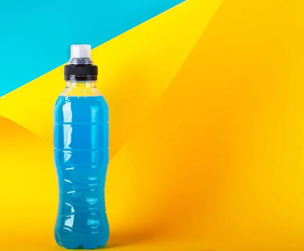원소 에너지 음료. 파란색 투명 액체병, 복사 공간이 있는 노란색 배경의 스포츠 음료 — 스톡 사진