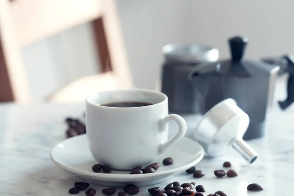 Hot cup of espresso or americano coffee in a traditional white cup on a table — Stock Photo, Image