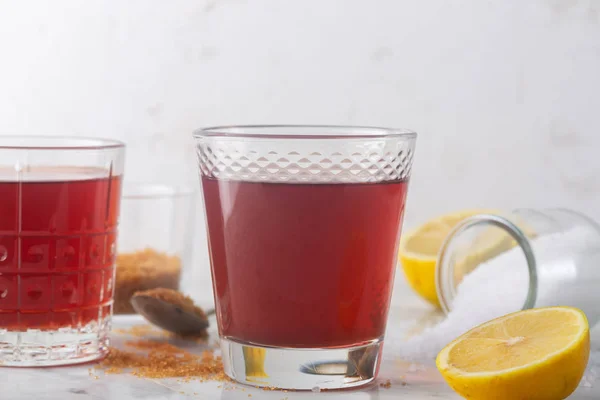 Σπιτικά ισοτονικό ενεργειακό ποτό και συστατικά. Γυαλί με κόκκινο υγρό, φυσικό άθλημα ποτό — Φωτογραφία Αρχείου