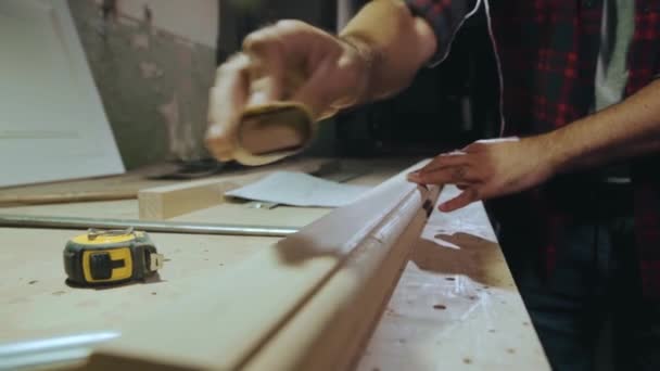 Close-up hand rubs a wooden product with sandpaper, slow motion — Stock Footage Close-up hand rubs a wooden product with sandpaper, slow motion Royalty Free Stock Footage