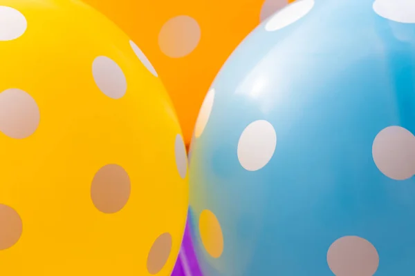 Background of blue, orange and yellow balloons with the white circles on them. The optimistic picture, the symbol of happiness and joy