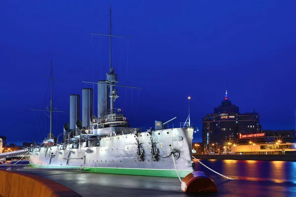 Russian cruiser Aurora in the mouth of Neva river in Petersburg near Nakhimov Naval School in the evening. The navy museum and the symbol of Great October revolution and Petersburg