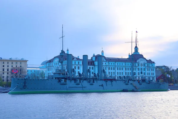 Russian cruiser Aurora in the mouth of Neva river in Petersburg on the background of Nakhimov Naval School in the evening. The navy museum and the symbol of Great October revolution and Petersburg