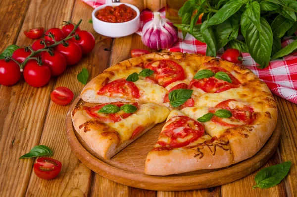 traditional Italian pizza margarita with tomatoes and mozzarella cheese