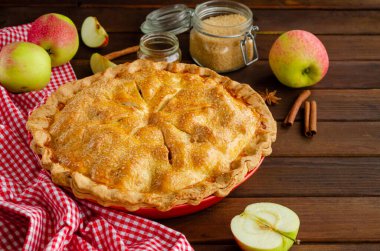 Classic American apple pie with cinnamon on a dark wooden background. Rustic style. Copy space clipart