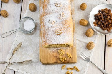 Şeker kaplı ceviz strudel ceviz ve kuru üzüm ahşap tahta üzerinde