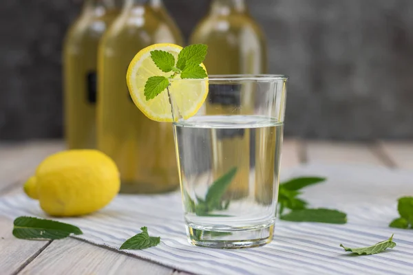 lemonade in a glass of homemade mint syrup with lemon slice