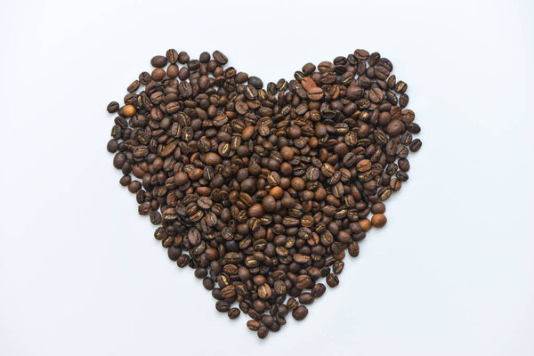 Coffee bean put in like heart on the white screen isolated