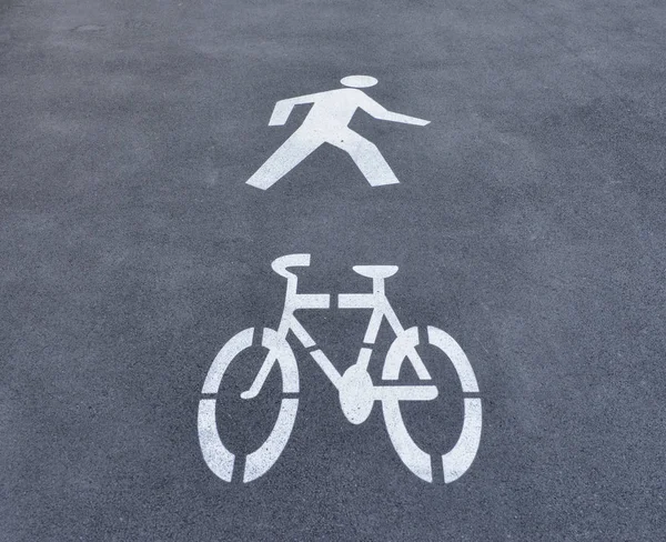 Walk way and bicycle lane sign on the road surface