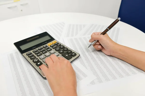 Mujer Mano Está Escribiendo Con Pluma Utilizando Calculadora Para Calcular — Foto de Stock